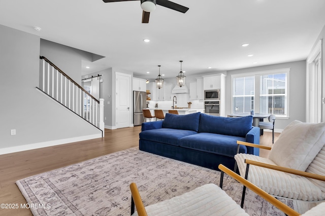 3 Devon Dr, Howell, NJ 07731 - living area with a barn door, ceiling fan, light wood finished floors, and recessed lighting