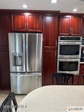 33 Tennent Ave, Englishtown, NJ 07726 - kitchen featuring stainless steel appliances, dark brown cabinets, light countertops, and recessed lighting