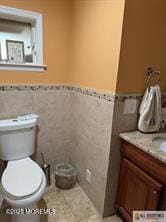 33 Tennent Ave, Englishtown, NJ 07726 - bathroom with vanity, tile walls, a wainscoted wall, and tile patterned flooring