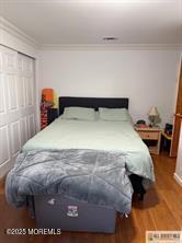 33 Tennent Ave, Englishtown, NJ 07726 - bedroom with ornamental molding, wood finished floors, and a closet