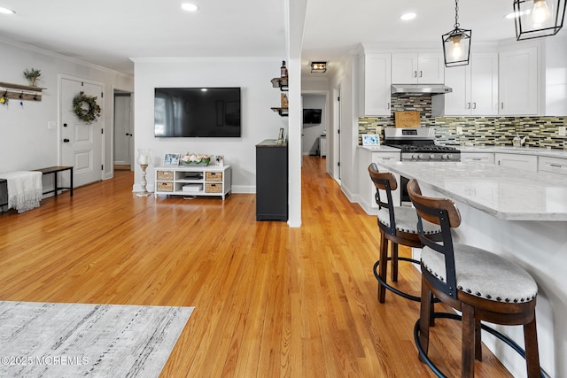 2120 Frances Dr, Point Pleasant, NJ 08742 - kitchen featuring stainless steel gas range oven, white cabinetry, ornamental molding, decorative backsplash, and light wood-style floors
