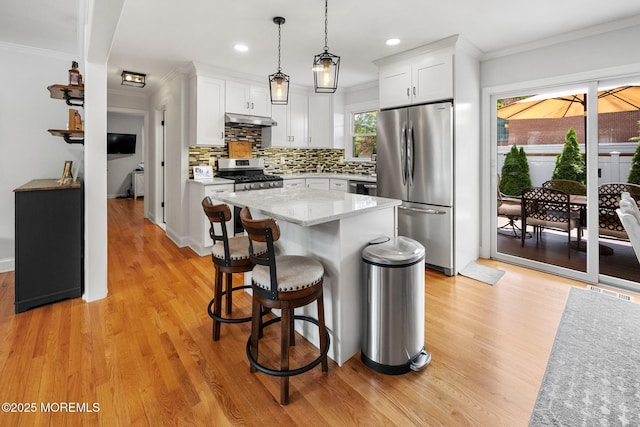2120 Frances Dr, Point Pleasant, NJ 08742 - kitchen featuring stainless steel appliances, ornamental molding, light wood-type flooring, white cabinetry, and backsplash