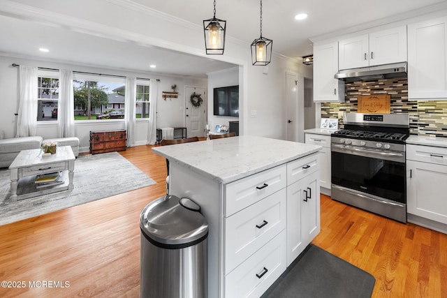 2120 Frances Dr, Point Pleasant, NJ 08742 - kitchen featuring stainless steel gas stove, under cabinet range hood, open floor plan, crown molding, and backsplash