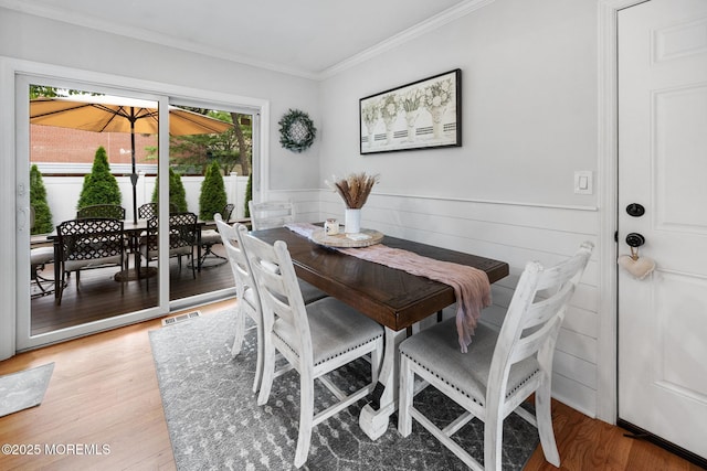2120 Frances Dr, Point Pleasant, NJ 08742 - dining area with light wood finished floors, ornamental molding, and wainscoting