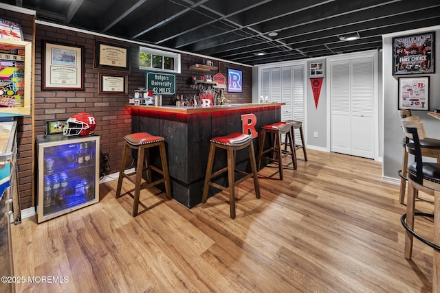 2120 Frances Dr, Point Pleasant, NJ 08742 - indoor dry bar with wine cooler, wood finished floors, and brick wall