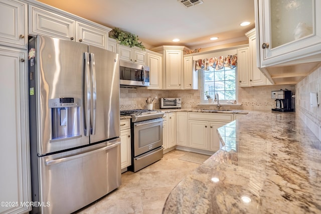 98 Everest S, Brick, NJ 08724 - kitchen with stainless steel appliances, decorative backsplash, light stone counters, recessed lighting, and glass insert cabinets