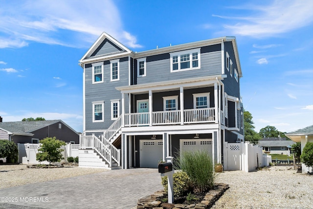 1735 Certainty Dr, Point Pleasant, NJ 08742 - raised beach house featuring stairway, a garage, decorative driveway, and a porch