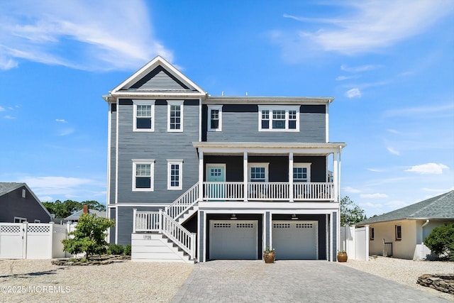 1735 Certainty Dr, Point Pleasant, NJ 08742 - coastal home with driveway, a porch, a garage, and stairs