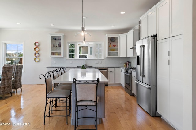 1735 Certainty Dr, Point Pleasant, NJ 08742 - kitchen with appliances with stainless steel finishes, a kitchen bar, tasteful backsplash, a kitchen island, and recessed lighting