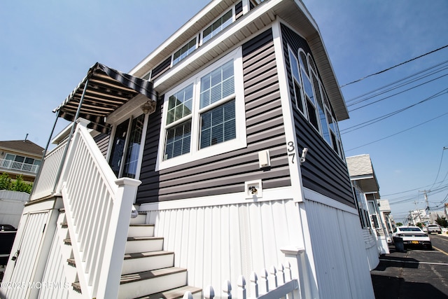 37 15th Ave, Seaside Park, NJ 08752 - view of side of home with stairs and board and batten siding