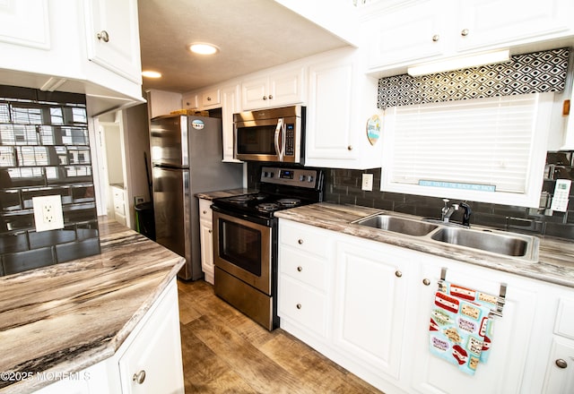 37 15th Ave, Seaside Park, NJ 08752 - kitchen with stainless steel appliances, tasteful backsplash, light wood finished floors, white cabinets, and recessed lighting