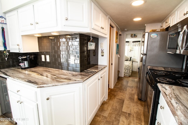 37 15th Ave, Seaside Park, NJ 08752 - kitchen with stainless steel microwave, electric range oven, white cabinets, tasteful backsplash, and recessed lighting