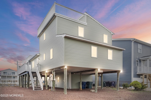 4 W Shrewsbury Dr, Little Egg Harbor, NJ 08087 - back of house at dusk featuring a carport and stairway