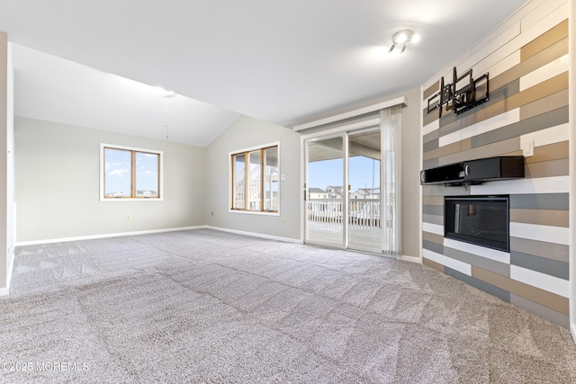 4 W Shrewsbury Dr, Little Egg Harbor, NJ 08087 - unfurnished living room with carpet, plenty of natural light, lofted ceiling, and a glass covered fireplace
