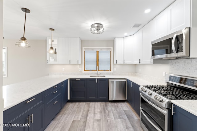 4 W Shrewsbury Dr, Little Egg Harbor, NJ 08087 - kitchen featuring appliances with stainless steel finishes, blue cabinets, light wood-style flooring, a peninsula, and recessed lighting