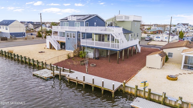 4 W Shrewsbury Dr, Little Egg Harbor, NJ 08087 - back of house with stairs, a residential view, a storage unit, and a deck with water view