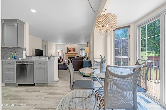 43 Winchester Dr, Howell, NJ 07731 - dining space with a chandelier, light wood finished floors, a fireplace, and recessed lighting