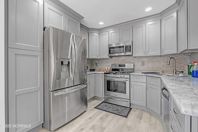43 Winchester Dr, Howell, NJ 07731 - kitchen featuring appliances with stainless steel finishes, recessed lighting, decorative backsplash, gray cabinetry, and light stone countertops