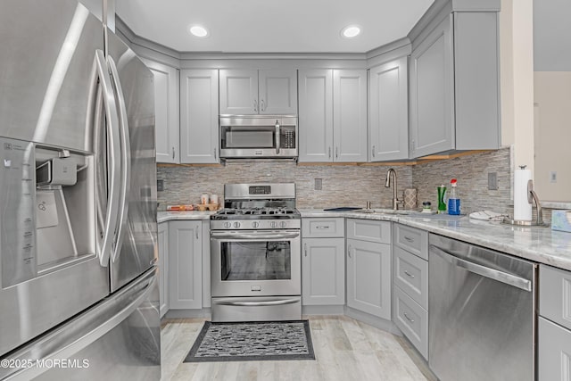 43 Winchester Dr, Howell, NJ 07731 - kitchen with stainless steel appliances, gray cabinetry, light stone countertops, tasteful backsplash, and recessed lighting