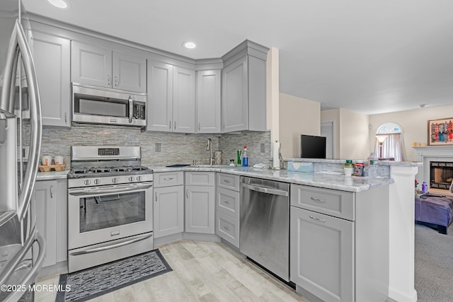 43 Winchester Dr, Howell, NJ 07731 - kitchen with appliances with stainless steel finishes, gray cabinetry, a peninsula, decorative backsplash, and recessed lighting