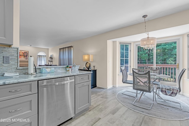 43 Winchester Dr, Howell, NJ 07731 - kitchen with stainless steel dishwasher, plenty of natural light, and light stone counters