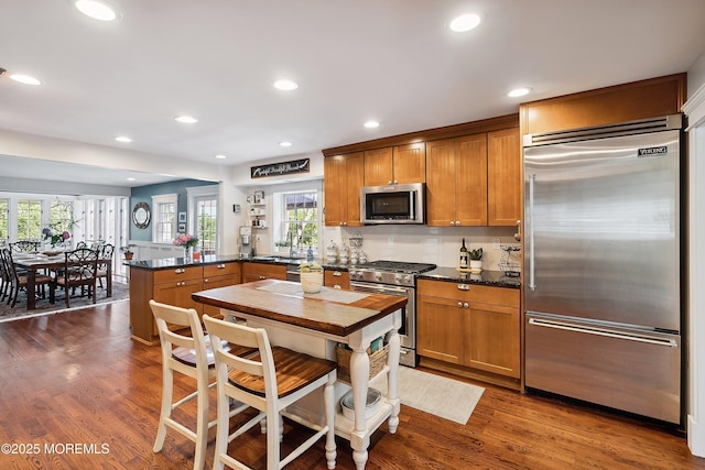 34 Sea View Ter, Highlands, NJ 07732 - kitchen with appliances with stainless steel finishes, a peninsula, recessed lighting, brown cabinetry, and dark wood-type flooring