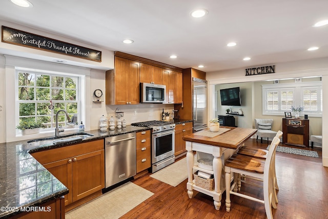 34 Sea View Ter, Highlands, NJ 07732 - kitchen with premium appliances, brown cabinets, dark wood-style floors, recessed lighting, and dark stone counters
