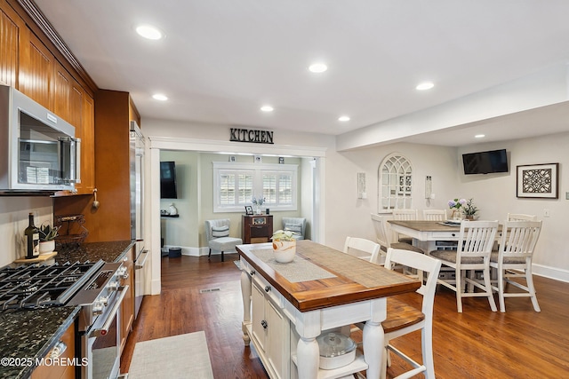 34 Sea View Ter, Highlands, NJ 07732 - kitchen with stainless steel appliances, dark wood finished floors, recessed lighting, wood counters, and brown cabinets