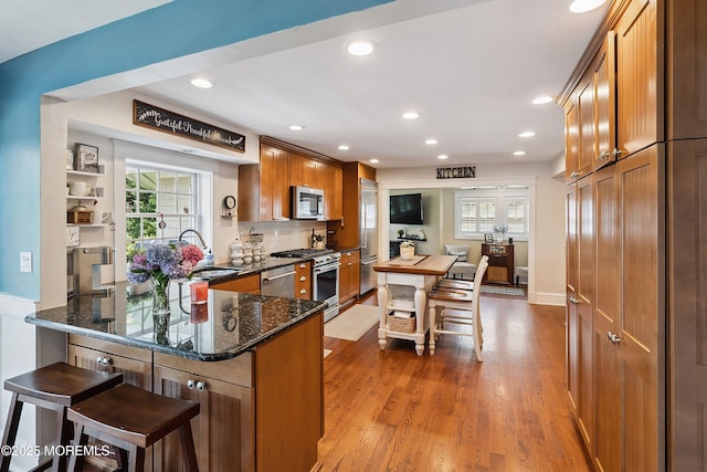 34 Sea View Ter, Highlands, NJ 07732 - kitchen with high end appliances, plenty of natural light, a peninsula, brown cabinetry, and recessed lighting