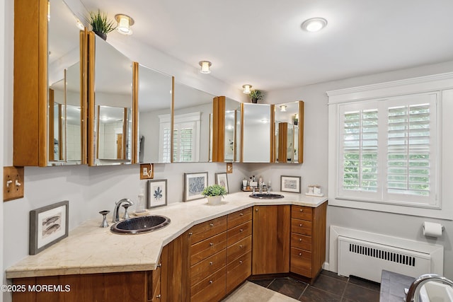 34 Sea View Ter, Highlands, NJ 07732 - bathroom featuring radiator, healthy amount of natural light, double vanity, and tile patterned floors
