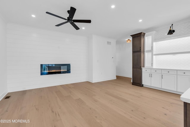 842 Arnold Ave Unit 4, Point Pleasant, NJ 08742 - unfurnished living room with crown molding, a fireplace, a ceiling fan, light wood-style floors, and recessed lighting