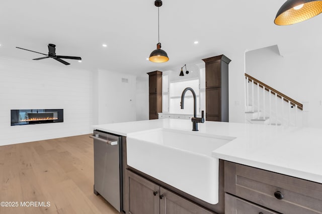 842 Arnold Ave Unit 4, Point Pleasant, NJ 08742 - kitchen featuring light wood-style floors, ceiling fan, light countertops, stainless steel dishwasher, and decorative light fixtures