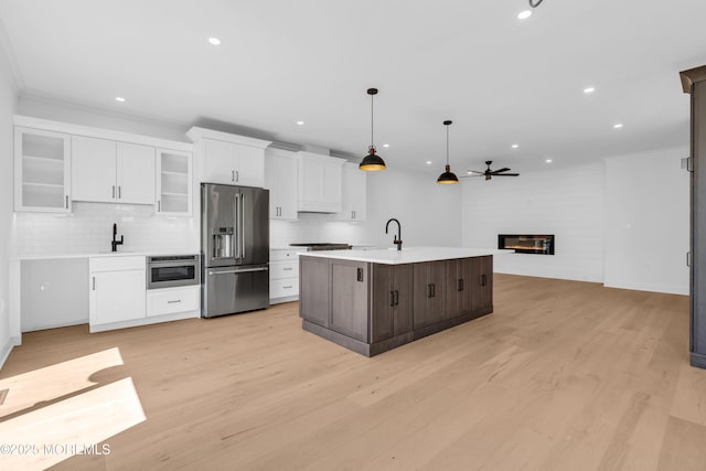 842 Arnold Ave Unit 4, Point Pleasant, NJ 08742 - kitchen with high end refrigerator, white cabinetry, light countertops, a glass covered fireplace, and backsplash