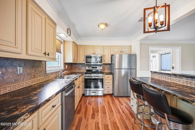 13 Brooke Rd, Brick, NJ 08724 - kitchen featuring stainless steel appliances, cream cabinets, dark countertops, crown molding, and light wood finished floors