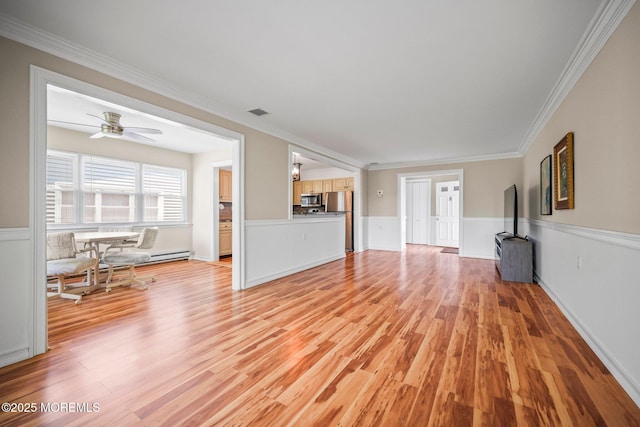 13 Brooke Rd, Brick, NJ 08724 - unfurnished living room featuring light wood finished floors, ornamental molding, a wainscoted wall, and a ceiling fan