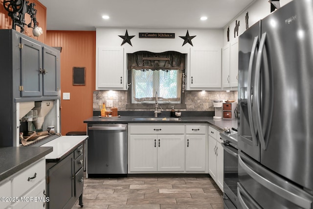 216 Main St, Port Monmouth, NJ 07758 - kitchen featuring appliances with stainless steel finishes, decorative backsplash, dark countertops, recessed lighting, and light wood finished floors