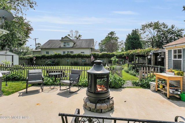 216 Main St, Port Monmouth, NJ 07758 - fenced backyard with a fire pit, a patio, and a storage shed