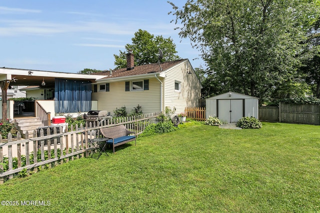 216 Main St, Port Monmouth, NJ 07758 - back of property featuring a storage unit, a chimney, a fenced backyard, and a wooden deck