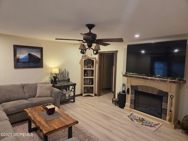 216 Main St, Port Monmouth, NJ 07758 - living area featuring light wood finished floors, a tile fireplace, and ceiling fan