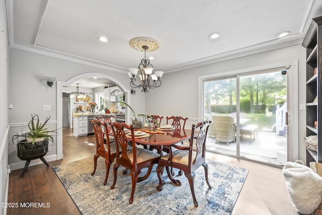 91 Newbury Rd, Howell, NJ 07731 - dining space with a chandelier, arched walkways, ornamental molding, recessed lighting, and wood finished floors
