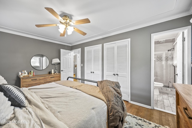 91 Newbury Rd, Howell, NJ 07731 - bedroom featuring two closets, wood finished floors, ornamental molding, connected bathroom, and ceiling fan