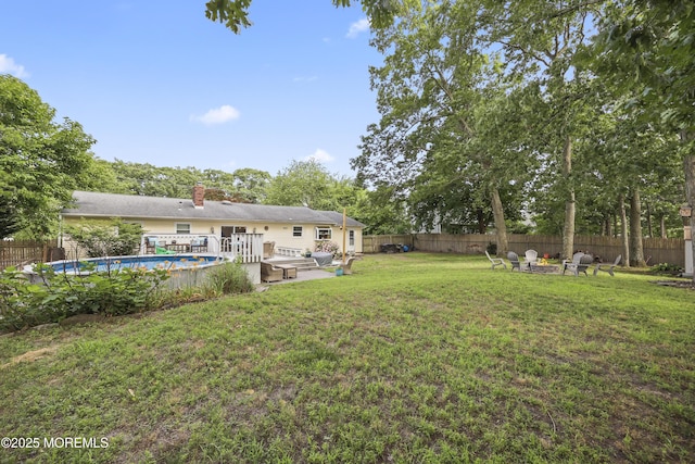 91 Newbury Rd, Howell, NJ 07731 - fenced backyard with a deck and an outdoor living space with a fire pit