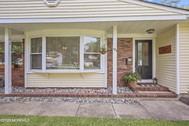 91 Newbury Rd, Howell, NJ 07731 - entrance to property with covered porch and brick siding