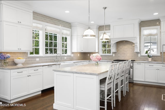 63 Bingham Ave, Rumson, NJ 07760 - kitchen with stainless steel range oven, a kitchen island, white cabinetry, dark wood-style flooring, and white dishwasher