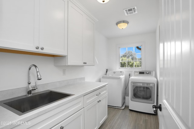 63 Bingham Ave, Rumson, NJ 07760 - laundry room featuring cabinet space, separate washer and dryer, and wood finished floors