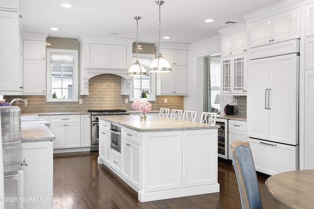 63 Bingham Ave, Rumson, NJ 07760 - kitchen with high end appliances, beverage cooler, white cabinetry, dark wood-type flooring, and backsplash