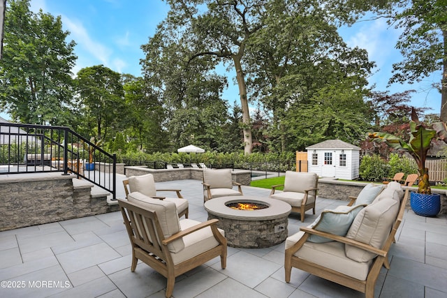 63 Bingham Ave, Rumson, NJ 07760 - view of patio featuring stairs, an outbuilding, an outdoor living space with a fire pit, and view of wooded area