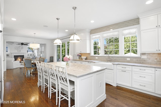 63 Bingham Ave, Rumson, NJ 07760 - kitchen with tasteful backsplash, a center island, white cabinetry, and recessed lighting
