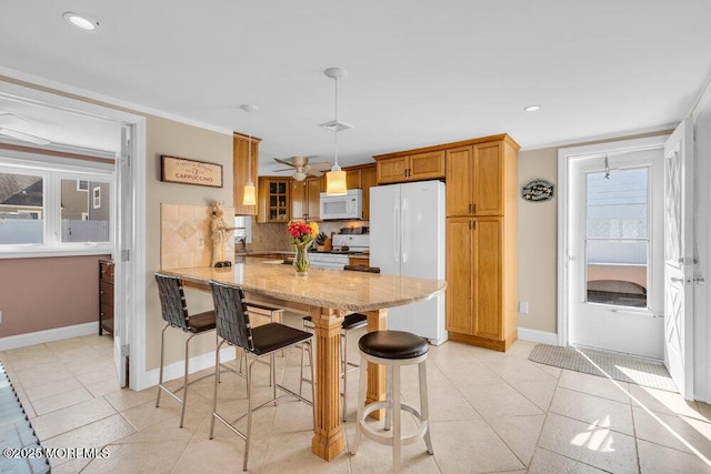 102 W Colony Rd, Lavallette, NJ 08735 - kitchen featuring white appliances, a peninsula, tasteful backsplash, a breakfast bar, and light stone countertops