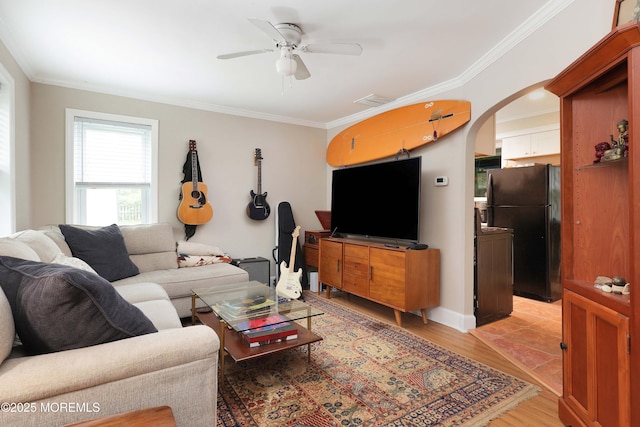 477 Lakewood Farmingdale Rd, Howell, NJ 07731 - living area featuring crown molding, arched walkways, a ceiling fan, and light wood-style floors